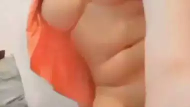 The naked girl fingers her wet pussy during a video call sex